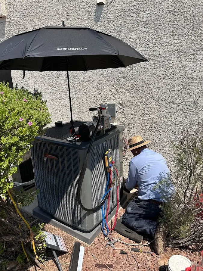 HVAC technician performing outdoor AC maintenance in Berkeley